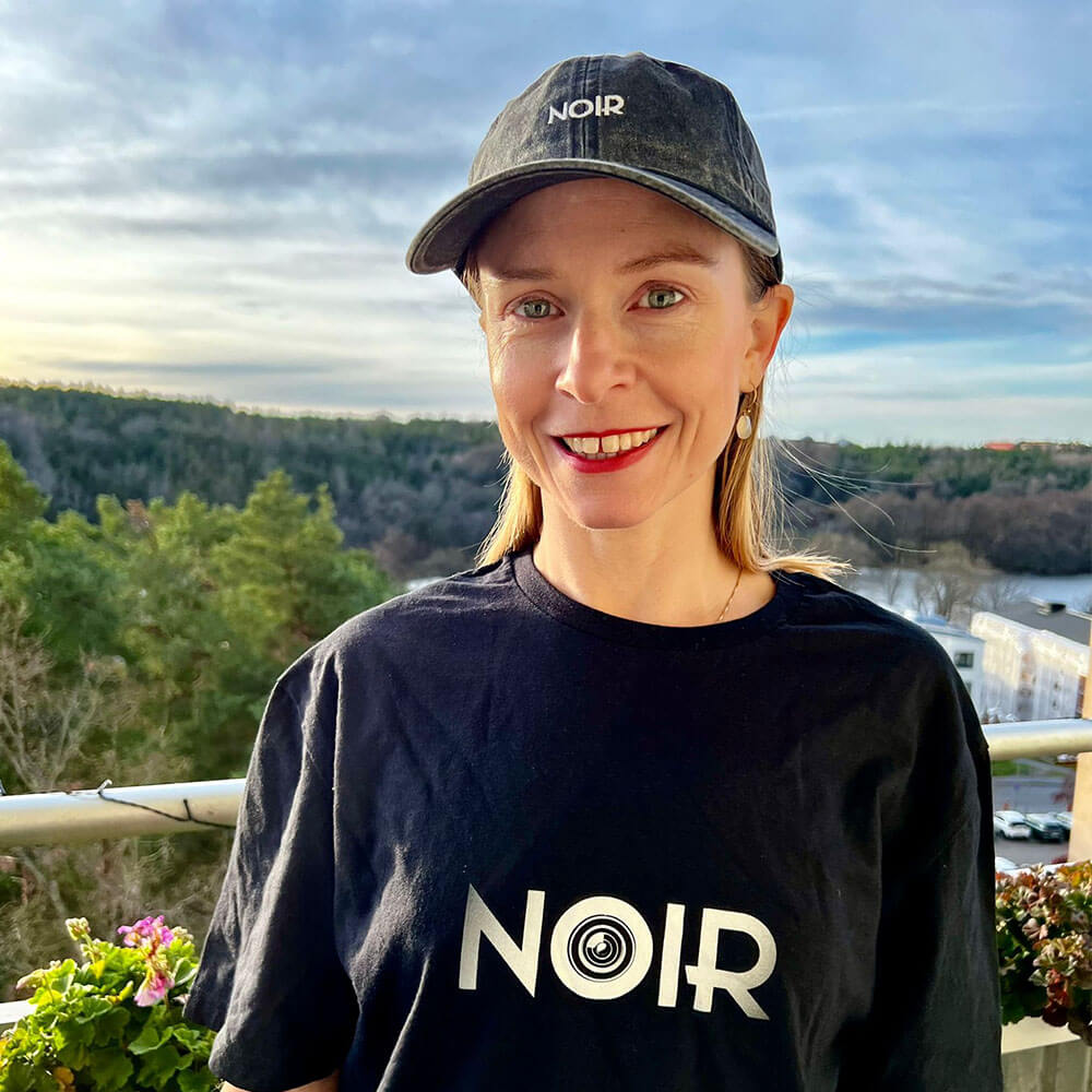 aequel film noir vintage cap black embroidered by sandra redlaff front woman smiling